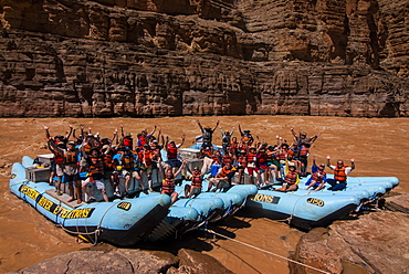 Happy tourists on two rafts celebrating, in the beautiful scenery of the Colorado River in the Grand Canyon, Arizona, United States of America, North America