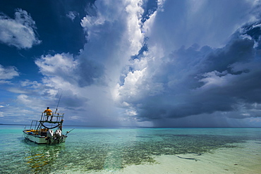 Little motor boat in the turquoise waters of the Ant Atoll, Pohnpei, Micronesia, Pacific