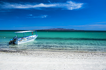 Boat on Playa Tecolote with Isla Espiritu Santo in the background, Baja California, Mexico, North America