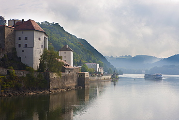 Cruise ship passing on the River Danube in the early morning mist, Passau, Bavaria, Germany, Europe 