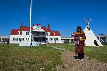 Indian dressed girl in front of a wigwam in Fort Union, North Dakota, United States of America, North America