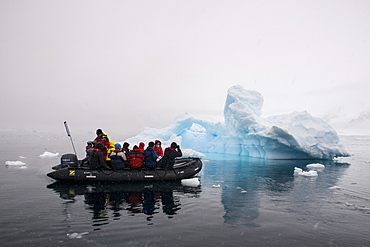 Tourists in a Zodiac crusing through icebergs, Enterprise Island, Antarctica, Polar Regions