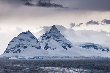 Dark clouds over the mountains and glaciers of Port Lockroy research station, Antarctica, Polar Regions