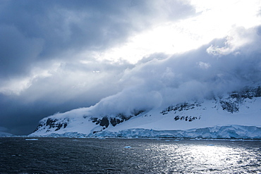 Dark clouds over the mountains and glaciers of Port Lockroy research station, Antarctica, Polar Regions