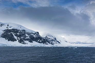 Dark clouds over the mountains and glaciers of Port Lockroy research station, Antarctica, Polar Regions