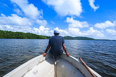 Man sitting on a boat near Nan Madol, Pohnpei Ponape), Federated States of Micronesia, Caroline Islands, Central Pacific, Pacific 