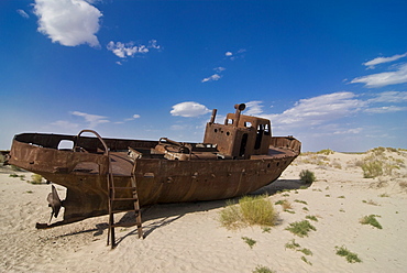 Rusting boats lying in the desert which used to be the Aral Sea, Moynaq, Uzbekistan, Central Asia