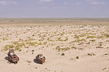 Rusting boats lying in the desert which used to be the Aral Sea, Moynaq, Uzbekistan, Central Asia