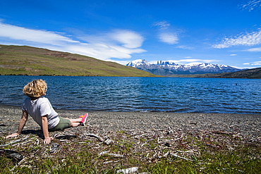 Woman enjoying a beautiful glacier lake in the Torres del Paine National Park, Patagonia, Chile, South America