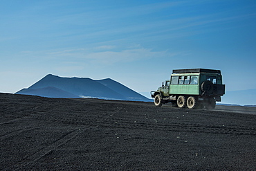 Russian truck drives through the lava sand field of the Tolbachik volcano, Kamchatka, Russia, Eurasia