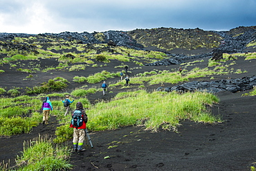 Tourists walking through the lava landscape of the Tolbachik volcano, Kamchatka, Russia, Eurasia 