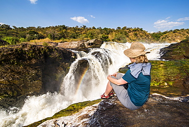 Woman looks at the stunning Murchison Falls (Kabarega Falls), Murchison Falls National Park, Uganda, East Africa, Africa