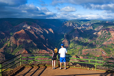 Tourists standing at a viewpoint overlooking the Waimea Canyon, Kauai, Hawaii, United States of America, Pacific