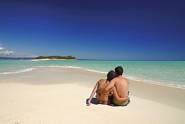 Couple enjoying their honeymoon on the very remote island of Nosy Iranja, off the coast of Madagascar, Indian Ocean, Africa