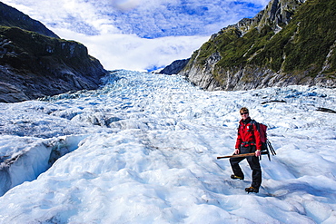 Tour guide hiking on the ice of Fox Glacier, Westland Tai Poutini National Park, South Island, New Zealand, Pacific