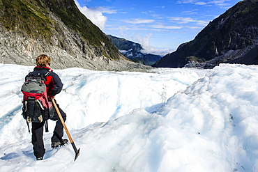 Tour guide hiking on the ice of Fox Glacier, Westland Tai Poutini National Park, South Island, New Zealand, Pacific