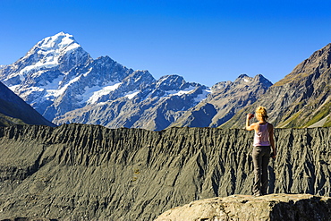 Woman photographing Mount Cook, South Island, New Zealand