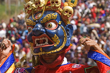 Masked dancer at religious festival with many visitors, Paro Tsechu, Paro, Bhutan, Asia