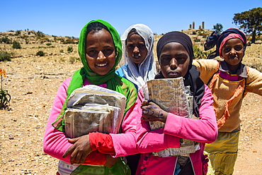 Colourfully dressed schoolgirls on their way home at the Pre-Aksumite settlement Qohaito, Eritrea, Africa