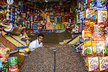 Man sitting in his full shop in the Old Town, UNESCO World Heritage Site, Sanaa, Yemen, Middle East