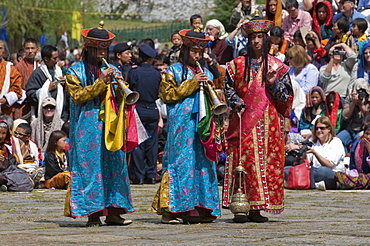 Buddhists playing the flute at religious festivity, Paro Tsechu, Paro, Bhutan, Asia