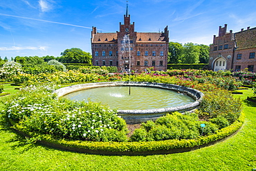 Fountain and roses in front of Castle Egeskov, Denmark, Scandinavia, Europe