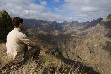 Man looking out over rocky landscape on island of San Antao, Cape Verde Islands, Africa