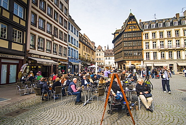 People at outdoor cafe with Restaurant Maison Kammerzell in background at Cathedral Square, Strasbourg, Alsace, France, Europe