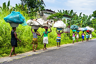 Women carrying giant baskets on their heads, northern Sao Tome, Sao Tome and Principe, Atlantic Ocean, Africa