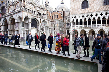 Tourists walking on footbridges during high tide in St. Mark's Square, Venice, UNESCO World Heritage Site, Veneto, Italy, Europe