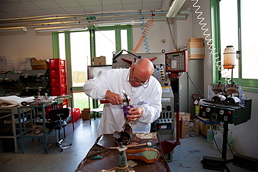 Teacher at work in the pattern making laboratory at Cercal footwear school and research center, San Mauro Pascoli, Emilia-Romagna, Italy, Europe