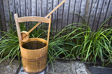 Traditional Japanese wooden bucket and ladle for washing sidewalk in a custom called uchimizu, Japan, Asia