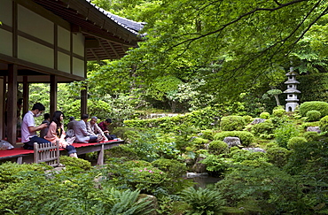 Visitors relaxing at a Zen meditation garden at Sanzenin Temple in Ohara, Kyoto, Japan, Asia