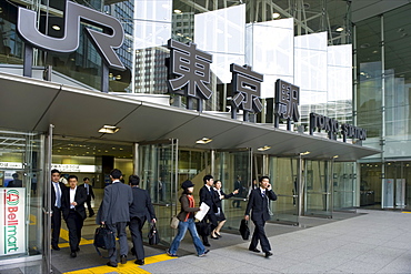 Business people at the contemporary glass entrance on the Otemachi side of Tokyo Station, Japan, Asia