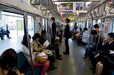 Passengers riding aboard the Yamanote loop line train that encircles greater metropolitan Tokyo, Japan, Asia