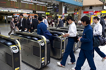 Passengers passing through automatic ticket wickets upon entering the JR Ueno railway station in Tokyo, Japan, Asia