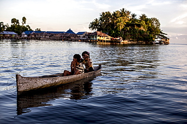 Two girls in a canoe, Togian Islands, Sulawesi, Indonesia, Southeast Asia, Asia