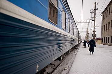 Providnistas remove snow and ice from the under the train, Trans-Siberian railway, Siberia, Russia, Europe