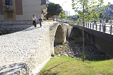 People walking over the Tanner's bridge, an Ottoman stone footbridge in Tirana, Albania, Europe