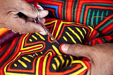 Kuna indigenous woman sewing a mola in the San Blas Islands, Panama, Central America