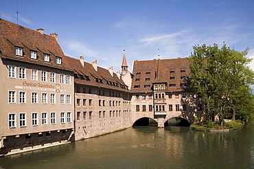 The Holy Ghost Hospital (Heilig-Geist-Spital), one of Europe's largest medieval hospitals, by the river Pegnitz in Nuremberg, Bavaria, Germany, Europe