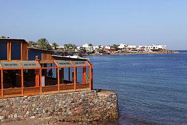 A restaurant overlooks the harbour of the Red Sea resort town of Dahab in Egypt, North Africa, Africa