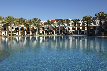 Rooms with verandas overlook a palm fringed swimming pool within the Royal Savoy Resort at Sharm el-Sheikh, Egypt, North Africa, Africa