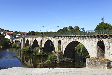 The medieval arched stone bridge across the River Lima at the town of Ponte da Barca, Minho, Portugal, Europe