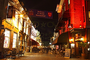 Busy bars and restaurants at night on Halstraat in Breda, Noord-Brabant, Netherlands, Europe