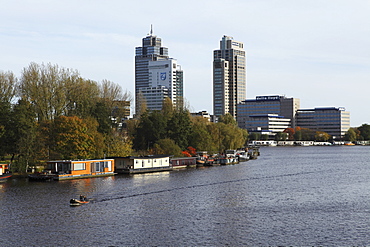 Skyscrapers and houseboats by the River Amstel in the Amstelveen district of Amsterdam, The Netherlands, Europe