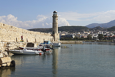 The Venetian era harbour walls and lighthouse at the Mediterranean port of Rethymnon, Crete, Greek Islands, Greece, Europe