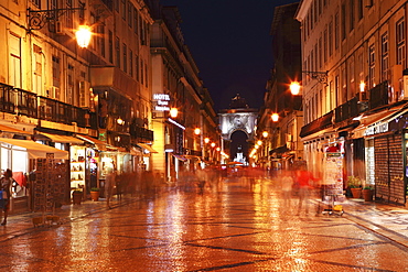 Warm summer's night on the cobbled Rua Augusta, leading to Arch of Rua Augusta, in the Baixa district of Lisbon, Portugal, Europe