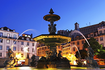 Illuminated fountain at night, Rossio Square (Praca do Dom Pedro IV), in the Baixa district of Lisbon, Portugal, Europe