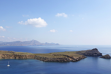 Rocky peninsulas of land poke into the Aegean Sea at Lindos, Rhodes, Dodecanese, Greek Islands, Greece, Europe